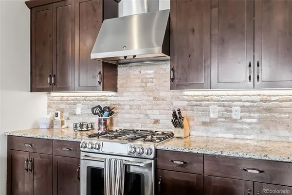 a kitchen with granite countertop cabinets stainless steel appliances and wooden cabinets