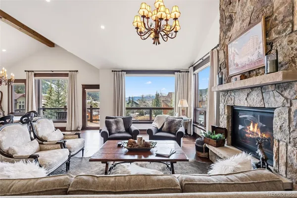 a living room with furniture large window and a fireplace