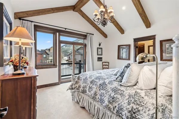 a bedroom with a bed and dresser with mirror