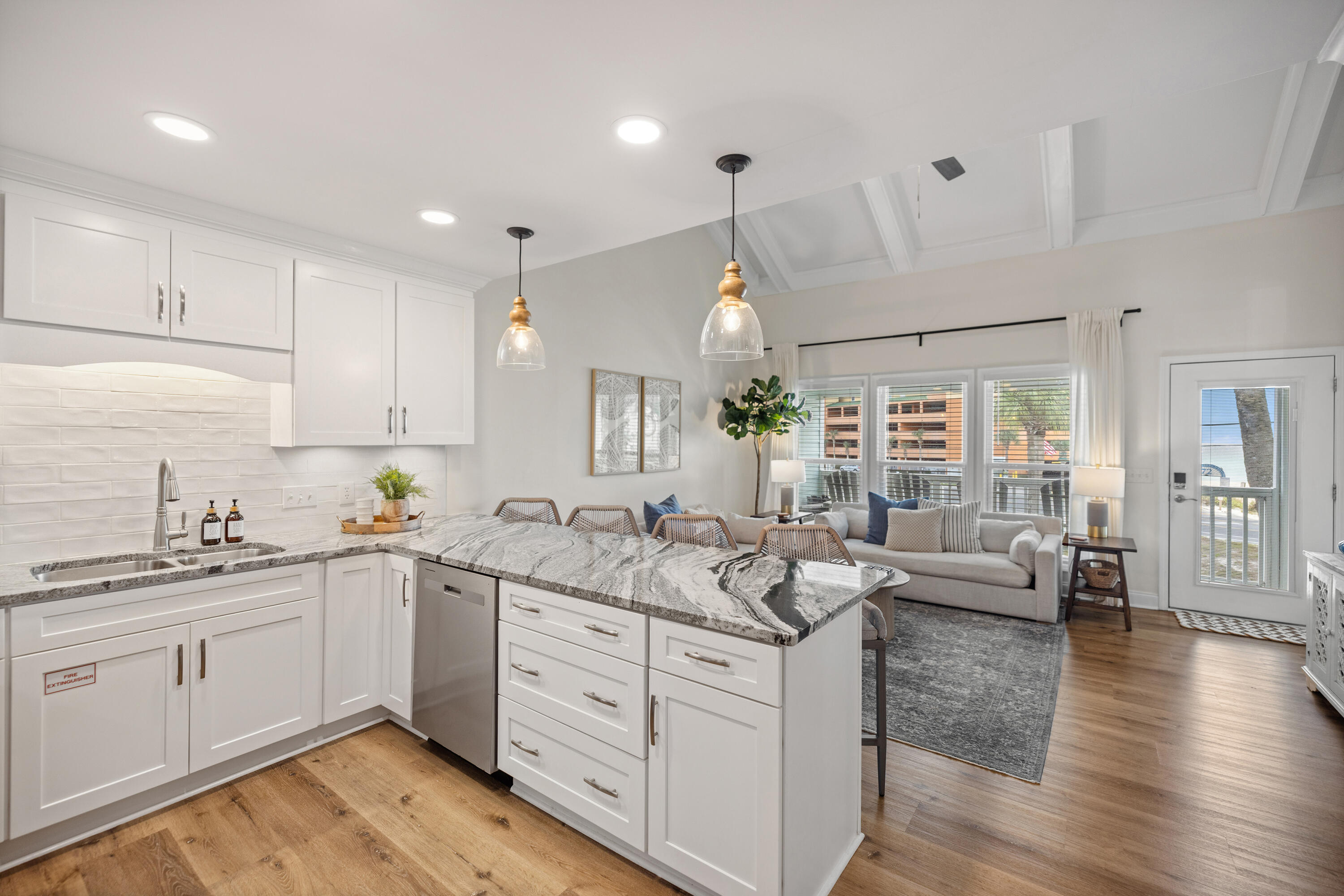 17670 Front Beach Road, Unit L7 Panama City Beach, FL 32413 - Photo 11 of 69 a kitchen with sink stove and wooden cabinets
