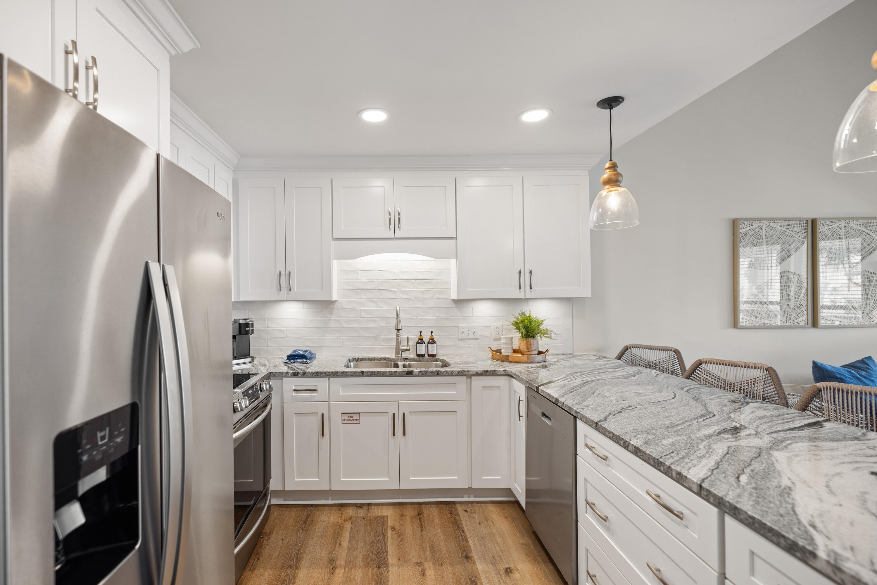 17670 Front Beach Road, Unit L7 Panama City Beach, FL 32413 - Photo 12 of 69 a kitchen with a sink a refrigerator and cabinets