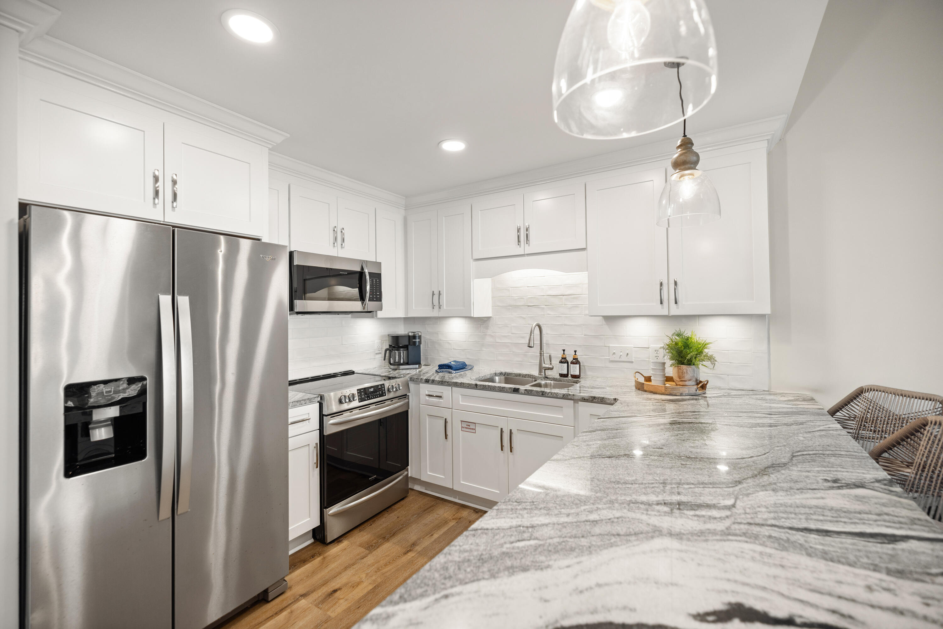 17670 Front Beach Road, Unit L7 Panama City Beach, FL 32413 - Photo 13 of 69 a kitchen with stainless steel appliances a refrigerator sink and microwave