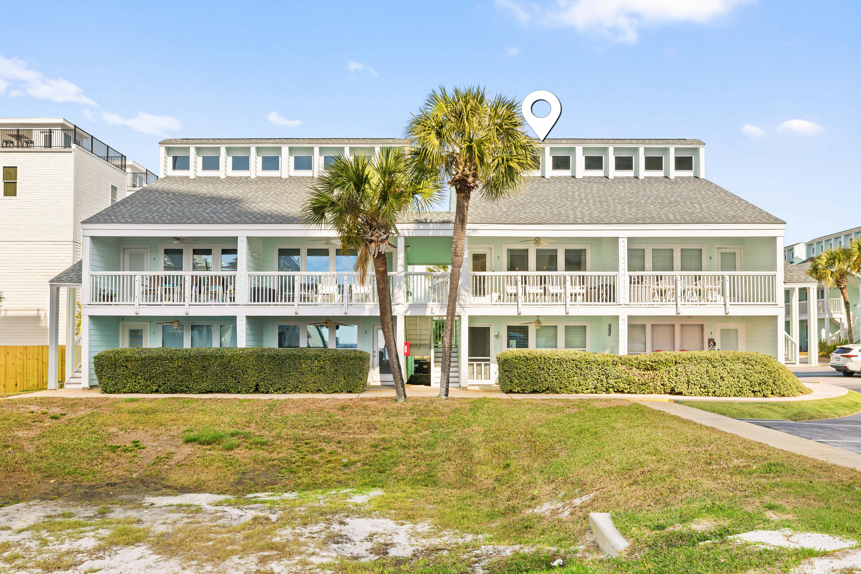17670 Front Beach Road, Unit L7 Panama City Beach, FL 32413 - Photo 2 of 69 a front view of a residential apartment building with a swimming pool