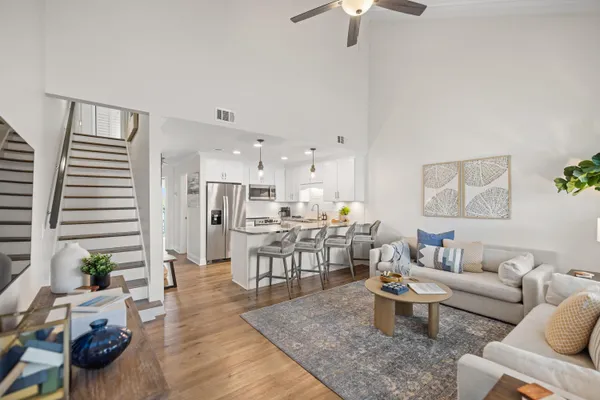 a living room with furniture and a dining table