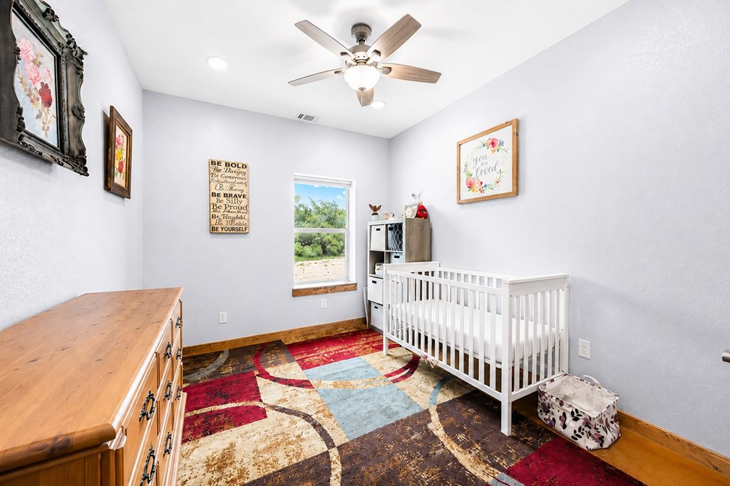 161 Balsly Road East Center Point, TX 78010 - Photo 22 of 28 a bedroom with a bed and a window