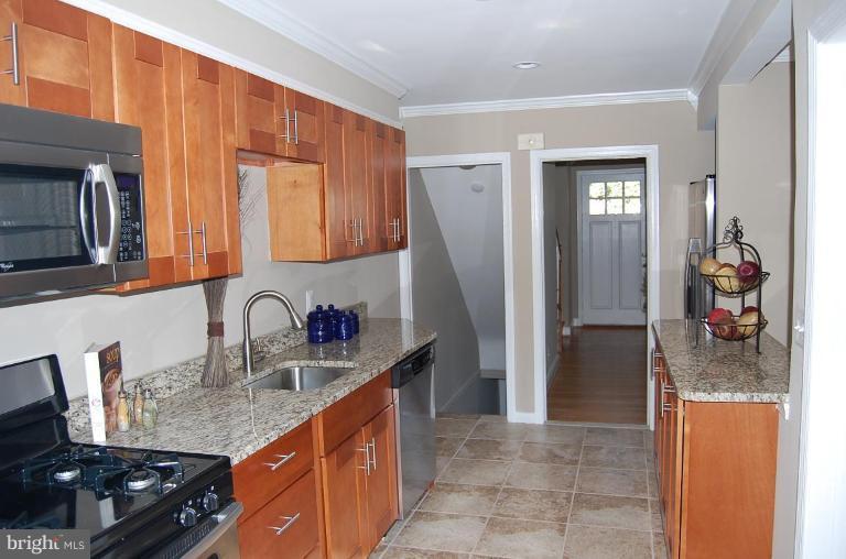 135 Stanmore Road Baltimore, MD 21212 - Photo 13 of 30 a kitchen with stainless steel appliances granite countertop a sink and a refrigerator