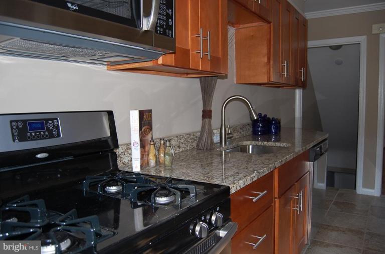 135 Stanmore Road Baltimore, MD 21212 - Photo 14 of 30 a kitchen with a stove and a sink