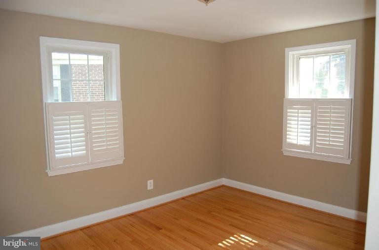 135 Stanmore Road Baltimore, MD 21212 - Photo 21 of 30 a view of an empty room with wooden floor and a window