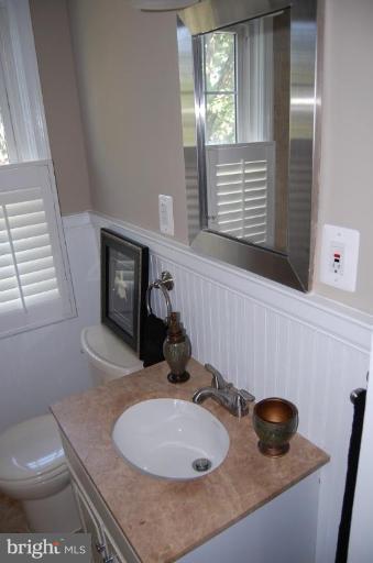 135 Stanmore Road Baltimore, MD 21212 - Photo 24 of 30 a bathroom with a granite countertop sink and a mirror