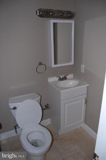 135 Stanmore Road Baltimore, MD 21212 - Photo 29 of 30 a white toilet sitting next to a bathroom sink