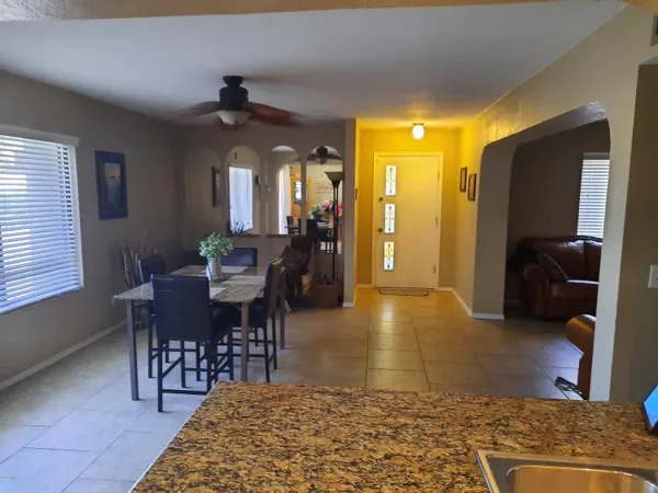 a view of a dining room with a table and chairs