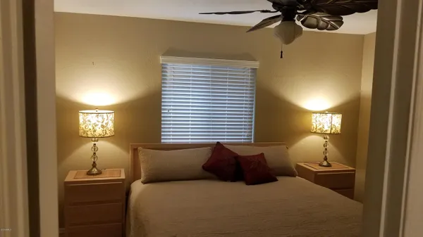 a bed room with a bed and a night stand