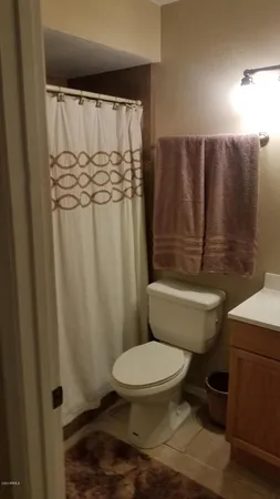 a bedroom with a bed and a lamp