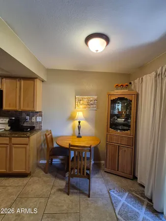 a kitchen with a table and chairs