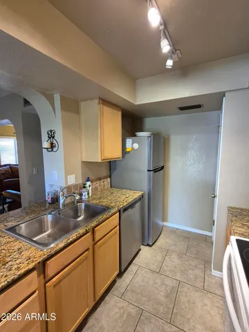 a view of a dining room with a table and chairs