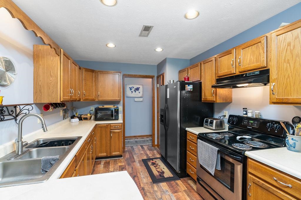 89 Swisher Road Staunton, VA 24401 - Photo 27 of 75 a kitchen with granite countertop a sink stove and refrigerator
