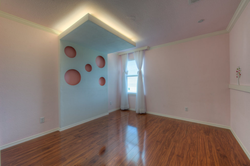 11204 Old Quarry Road Austin, TX 78717 - Photo 16 of 18 Polished hardwood flooring and crown molding accent this bedroom with an architectural alcove.