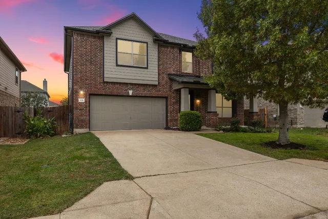 a front view of a house with a yard and garage