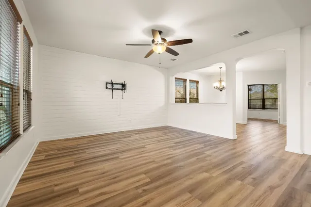 wooden floor in an empty room with a window