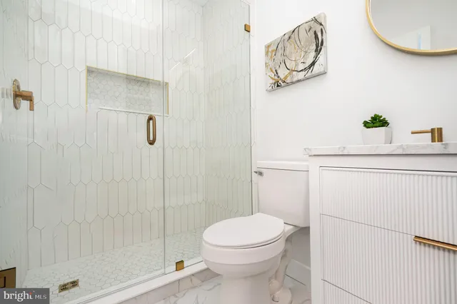 a bathroom with a toilet a sink and shower