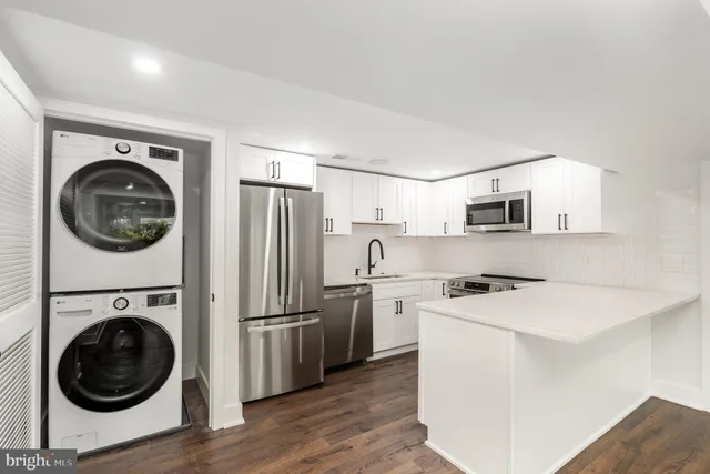 a kitchen with a stove top oven sink and a refrigerator
