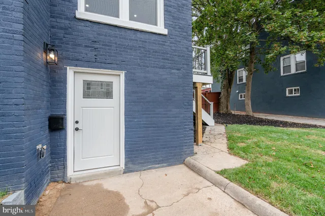 a view of brick house with a yard