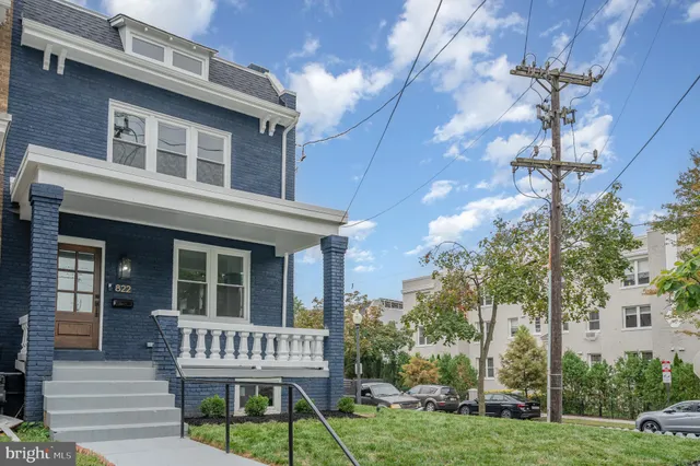 a view of a house with backyard porch and sitting area
