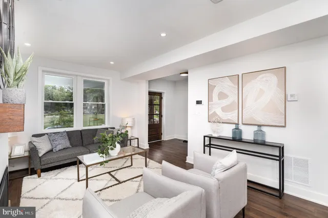 a living room with furniture and a potted plant on table