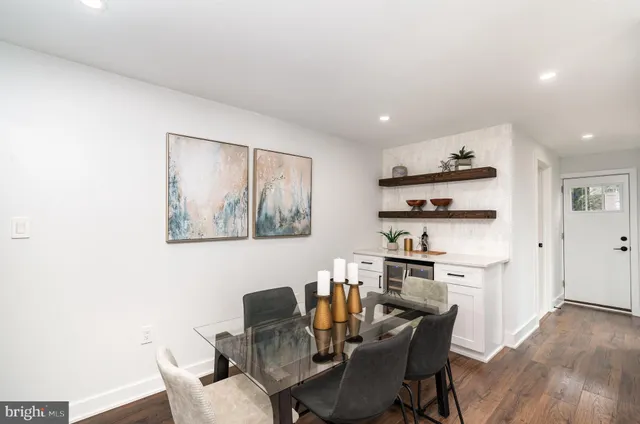 a dining room with furniture and wooden floor
