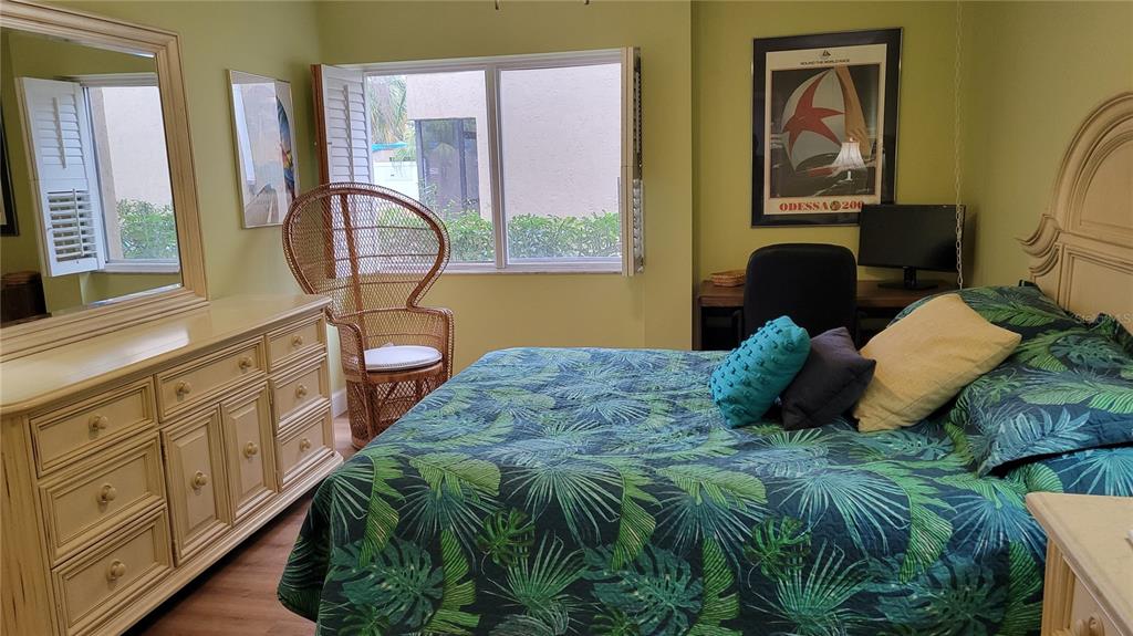 2938 Clark Road, Unit 104 Sarasota, FL 34231 - Photo 11 of 18 a bed sitting in a bedroom next to a window