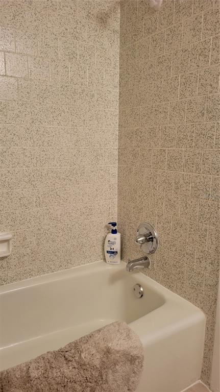 2938 Clark Road, Unit 104 Sarasota, FL 34231 - Photo 15 of 18 a bathroom with a bathtub