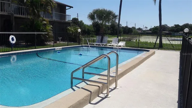 a view of a swimming pool with a deck