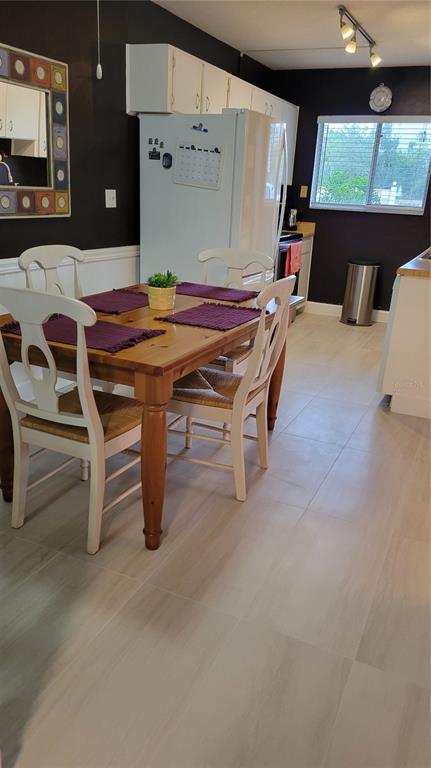 2938 Clark Road, Unit 104 Sarasota, FL 34231 - Photo 5 of 18 a dining room with furniture and window