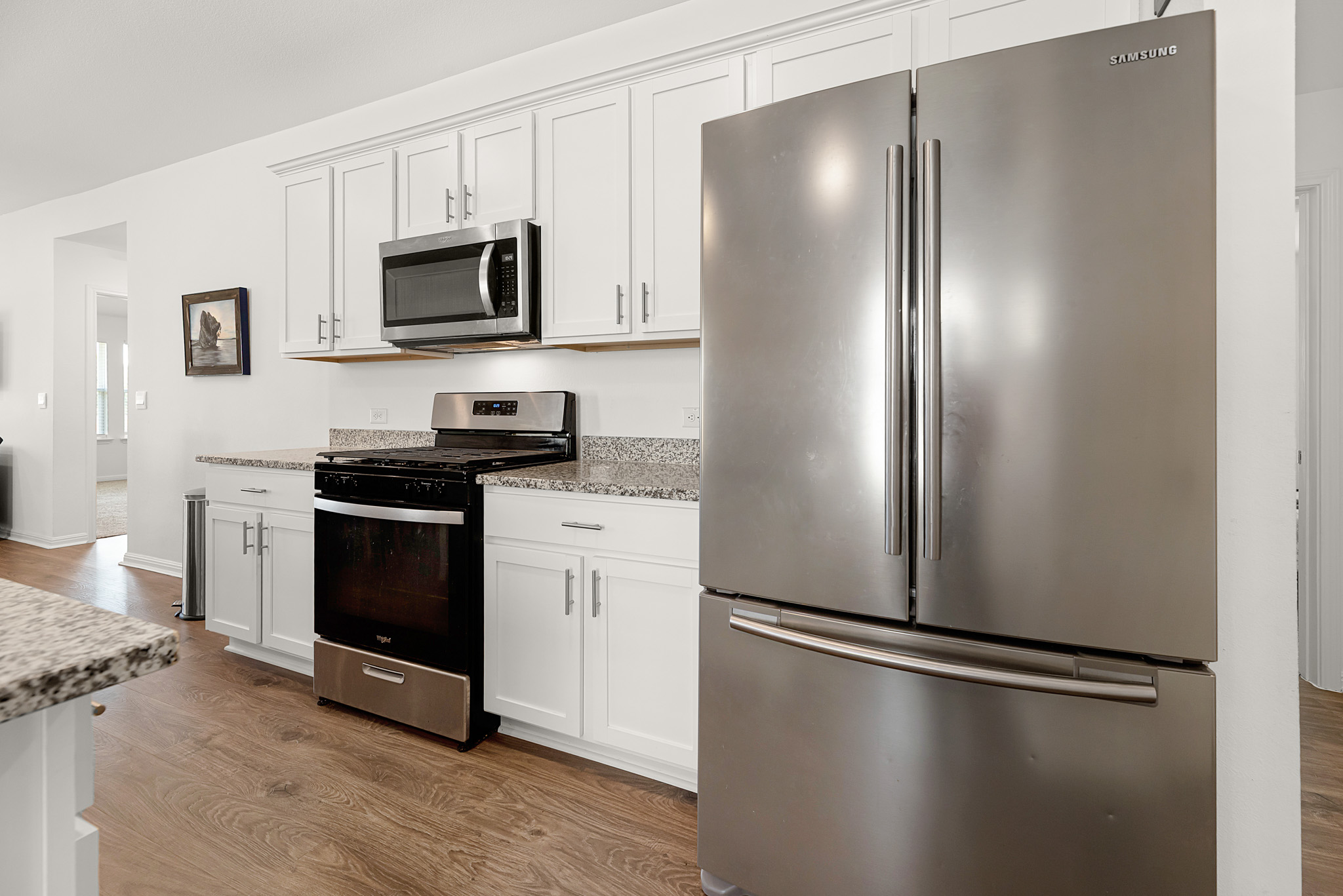 165 Santa Rosa Lane Buda, TX 78610 - Photo 4 of 21 a kitchen with stainless steel appliances a refrigerator stove and microwave
