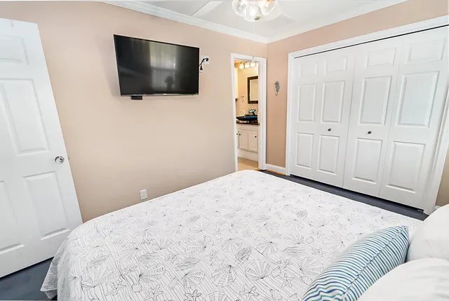 a bedroom with a bed and a flat screen tv