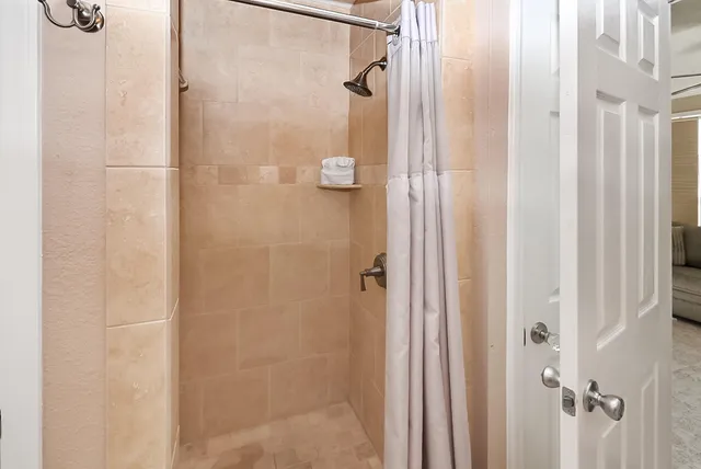 a bathroom with a glass shower door