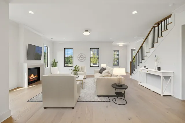 an empty room with windows and fireplace