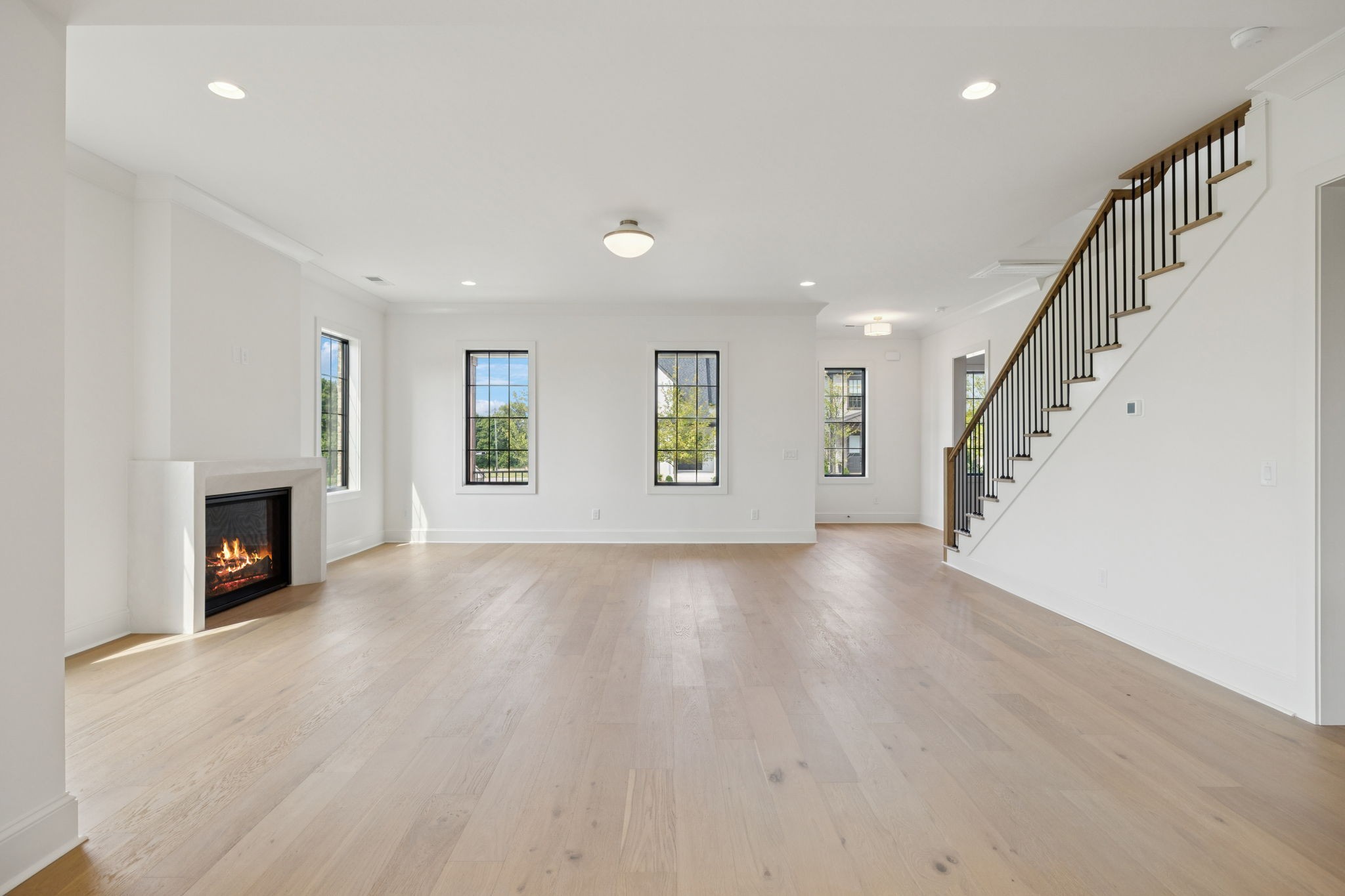 102 Cardiff Dr Spring Hill North Thompson's Station, TN 37179 - Photo 20 of 67 a view of an empty room with wooden floor fireplace and a window