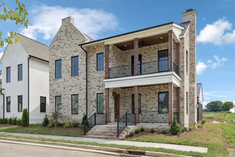 a living room with furniture a fireplace and a large window