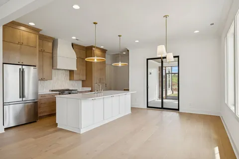 a bedroom with a bed chandelier and a window