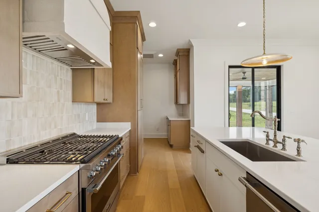 a bedroom with a large bed and a chandelier