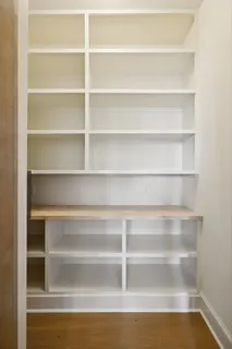 a view of walk in closet with empty room