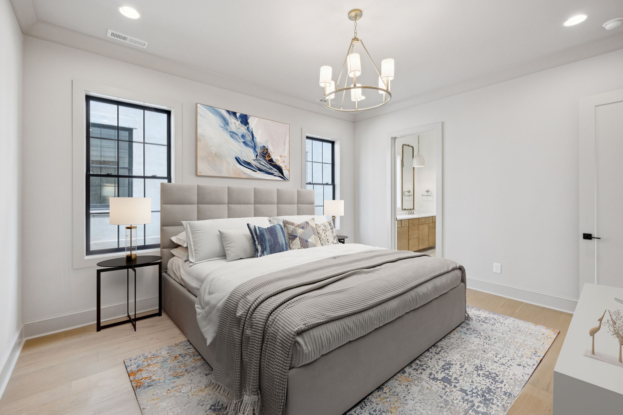 102 Cardiff Dr Spring Hill North Thompson's Station, TN 37179 - Photo 33 of 67 a bedroom with a large bed and a chandelier