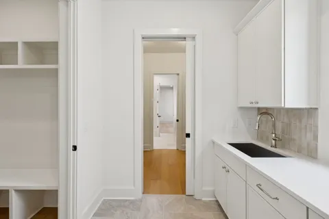 a bathroom with a granite countertop sink a toilet and a mirror