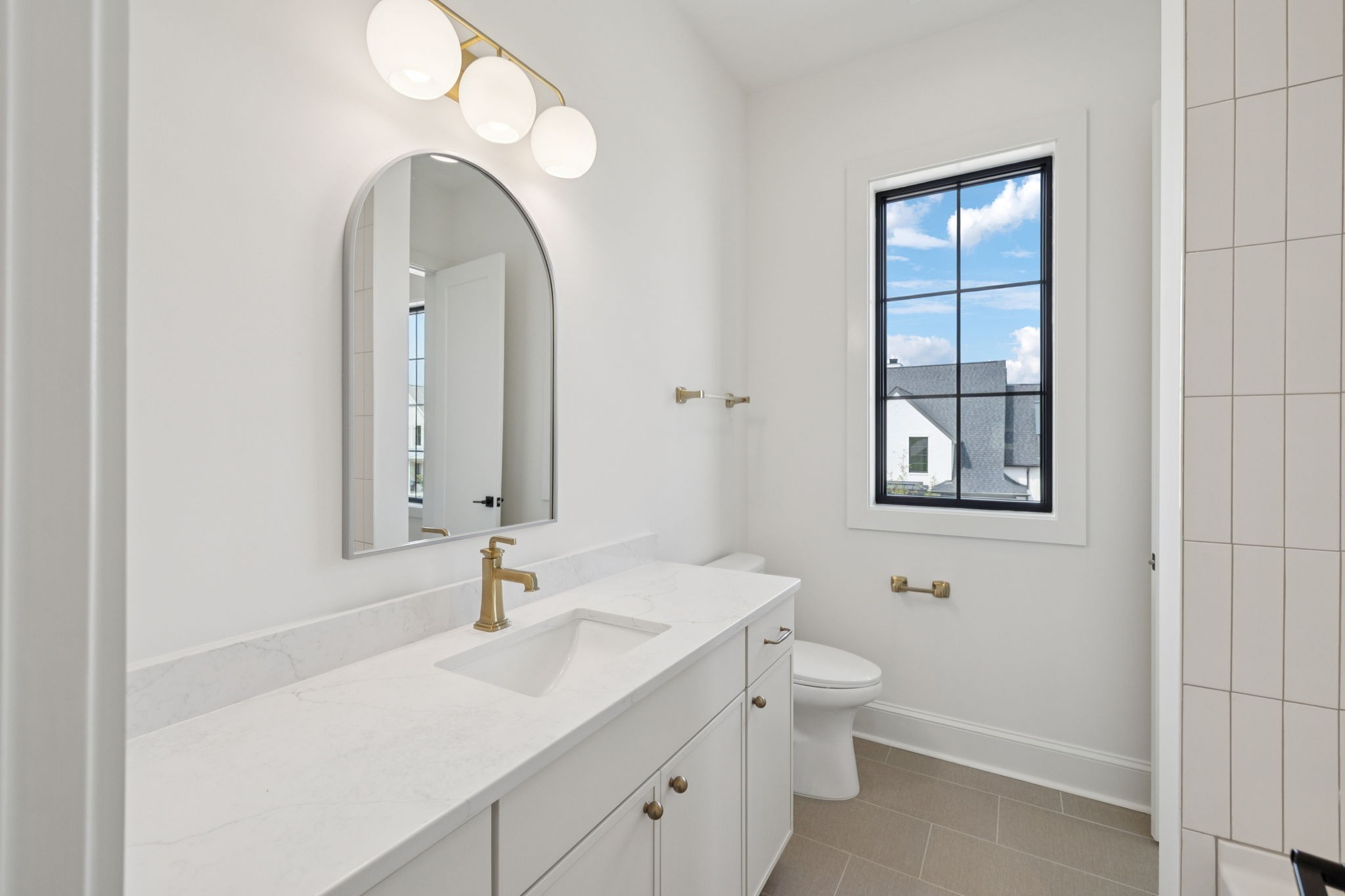 102 Cardiff Dr Spring Hill North Thompson's Station, TN 37179 - Photo 46 of 67 a bathroom with a granite countertop sink a toilet and a mirror