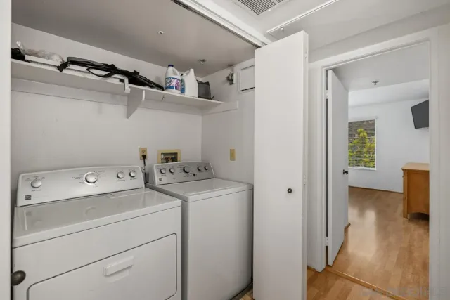 a view of storage and utility room with washer and dryer