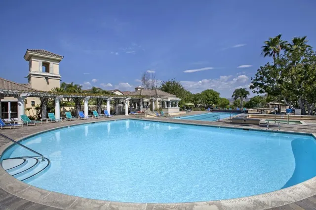 swimming pool view with a seating space and a garden view