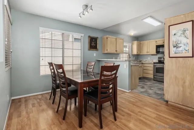 a view of a dining room with furniture and wooden floor