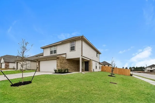 a backyard of a house with table and chairs