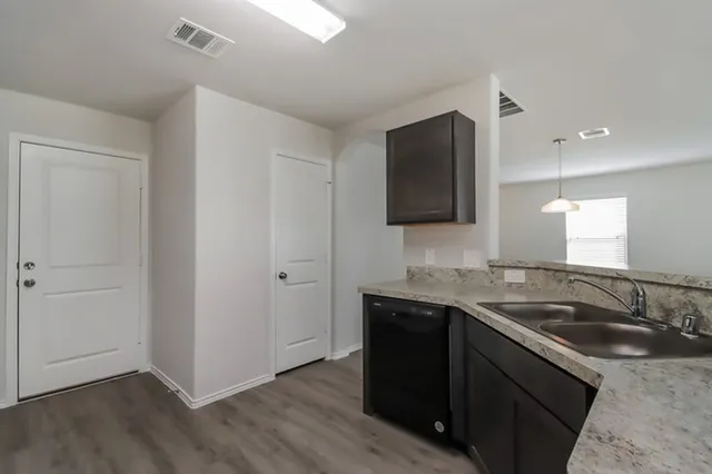 a kitchen with a sink and a refrigerator